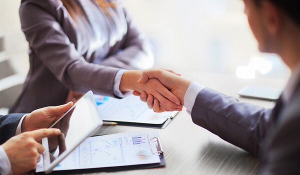 Woman and man shaking hands